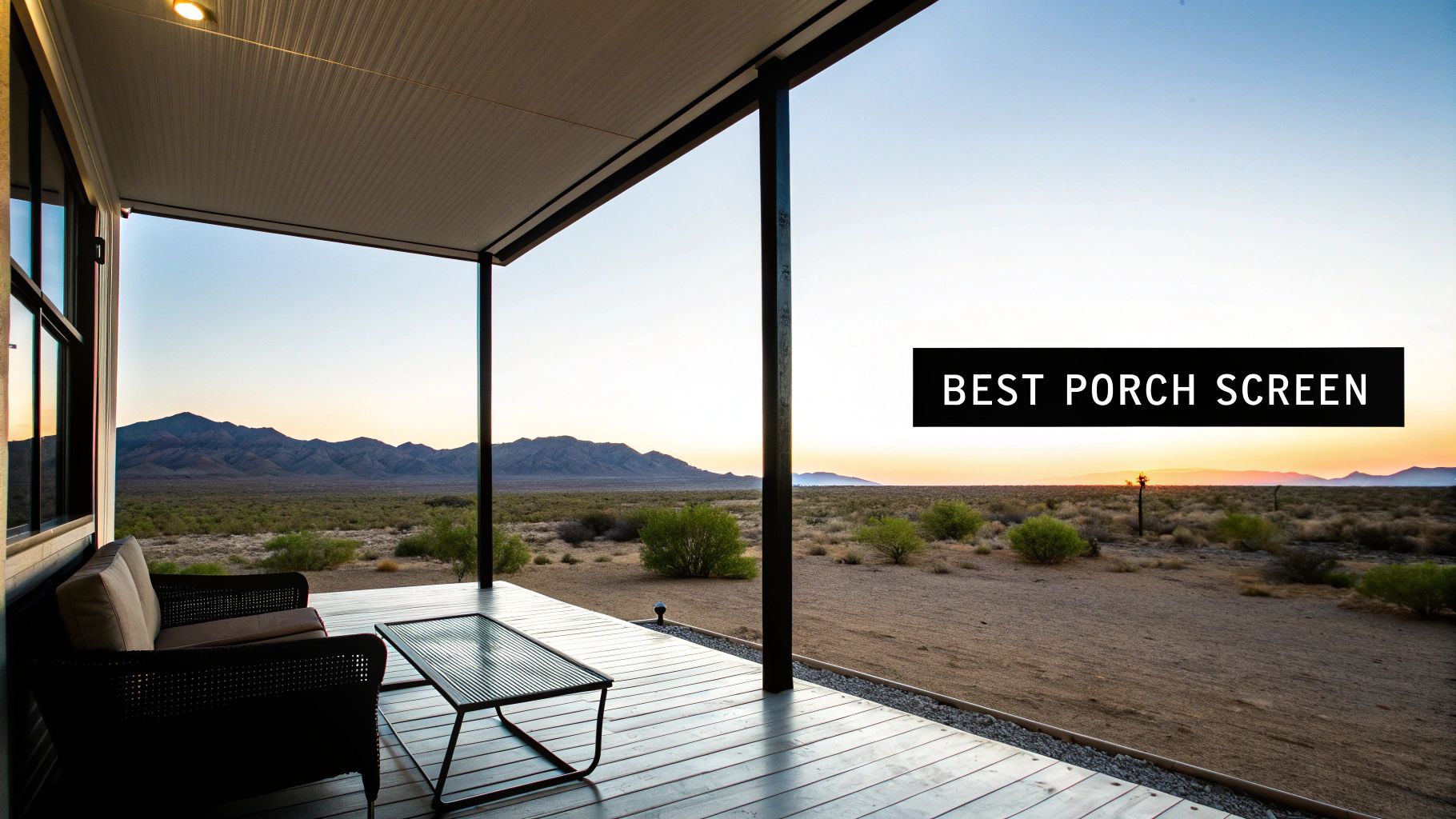 A modern porch with outdoor furniture overlooking a vast desert landscape and mountains at sunset.